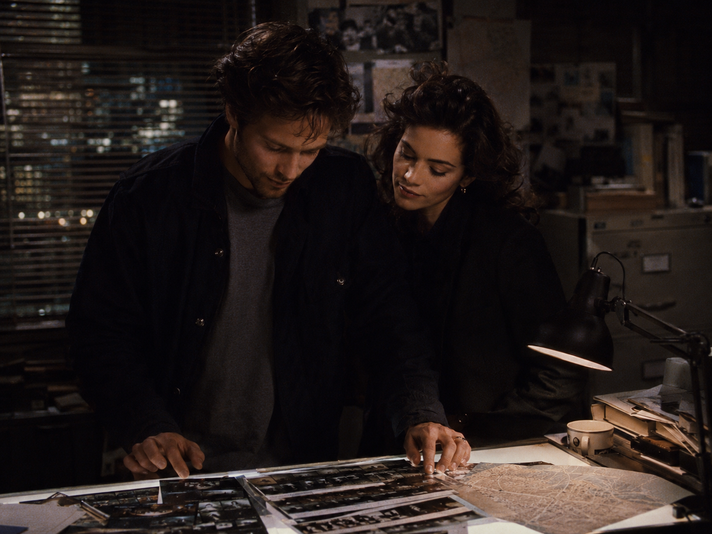 Jack and Nora examine contact sheets over a light table
